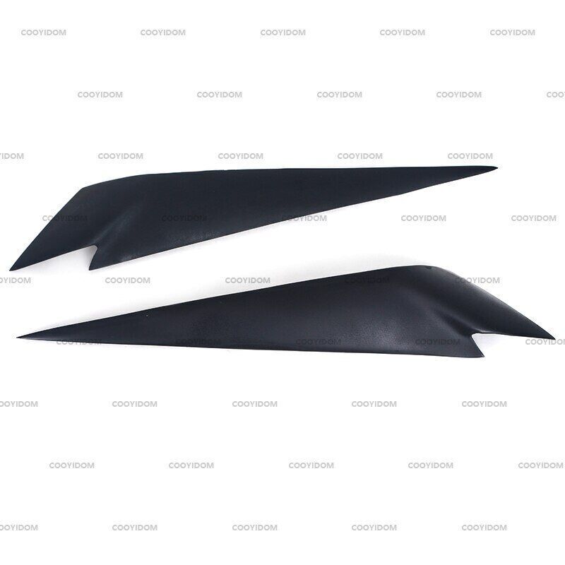 A pair of black headlight brow-shaped cover eyelid trims for 2009-2014 for BMW X1 E84